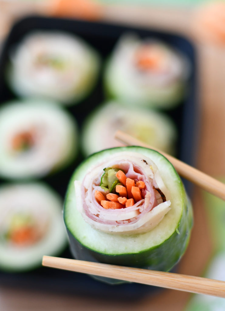 Chopsticks holding Cucumber Sushi Rolls