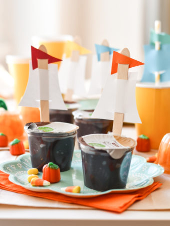 A thanksgiving table set for kids with dairy free Mayflower Pudding Cups on a turquoise plate