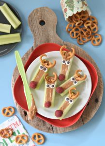 This season we are taking the classic Ants on a Log snack and throwing a holiday twist on it with these Peanut Butter Celery Reindeer Sticks!