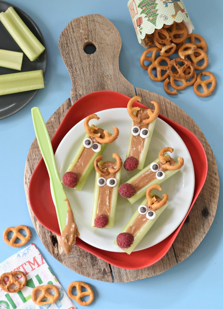 This season we are taking the classic Ants on a Log snack and throwing a holiday twist on it with these Peanut Butter Celery Reindeer Sticks! #christmasfood #funfood #kidfood